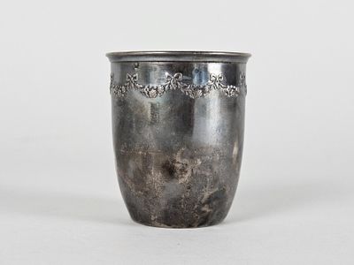 a silver cup that is sitting on a table