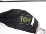 a black umbrella with a label on it on a white surface