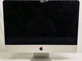 an apple computer monitor sitting on top of a white table
