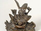 bronze statue of a bird and a duck in a pond of water