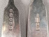 two spoons sitting next to each other on a table