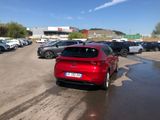 a red car that is parked in a parking lot