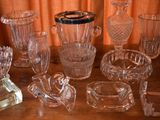 a lot of glass items sitting on a wooden table