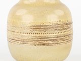 a vase that is sitting on a white surface