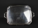 a silver tray with handles on a black background
