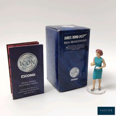 a figurine of a woman standing next to a box of books
