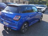 a blue car that is parked in a parking lot
