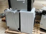 a pile of appliances sitting on a pallet in a warehouse