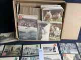 a lot of old postcards in a box on the table