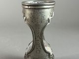 an image of a silver cup with a bird on it