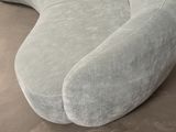 an image of a curved couch in a living room