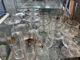 a lot of glasses that are sitting on a glass table