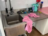 a kitchen with a sink and a refrigerator in it
