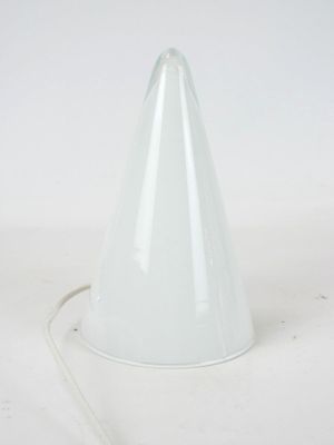a white cone shaped lamp on a white surface