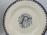 three blue and white plates with designs on them sitting on a table