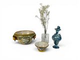 three vases, a bowl, and a vase with flowers in them