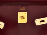 hermes ' s burgundy leather handbag with gold hardware and two handles