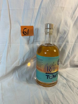 a bottle of rum in front of a white sheet