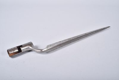 a small metal tool that is on a white surface
