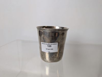 a silver cup sitting on a table with a label on it