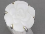 a close up of a ring with a flower on top of it