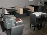 a table and chairs in a room with a lot of books on the table