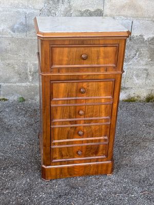an old wooden chest of drawers with marble top