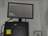 a computer monitor and other electronics on a shelf