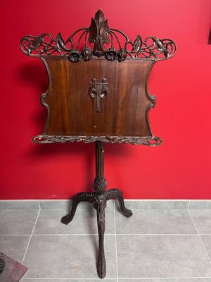 a wooden table with a clock on it in a red room