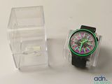 a watch that is sitting next to a clear box