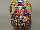 a blue and gold vase sitting on a table