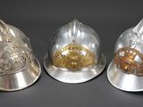 three different types of helmets are shown on a black surface