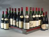 many bottles of wine sitting on a wooden tray
