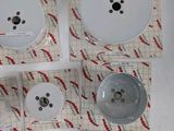 four pieces of white buttons on a piece of paper