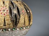 a close up of a vase with a decorative decoration on it