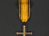 an image of a medal with a cross on it on a black background