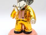 gold and silver elephant figurine with a crown on top of a pink base