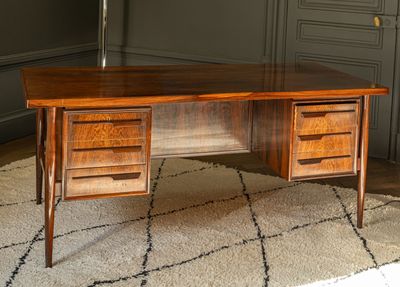 a wooden desk with two drawers and a lamp on top of it