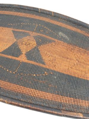 a close up of a woven basket with a bird on it