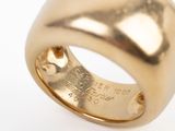 an image of a close up of a gold ring on a white surface