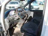 a white van with a black seat and a black bag in it