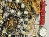 a pile of assorted jewelry sitting on a table