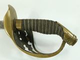 a close up of a sword on a white surface