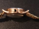 an image of a close up of a watch on a table
