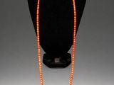 a close up of a necklace on a mannequin display