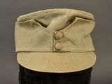 the hat is tan and has buttons on the front