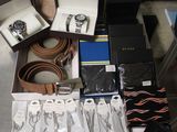 a lot of watches, belts, and other items on the table