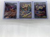 three different pokemon cards sitting on top of each other on a table