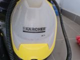 a yellow and black steam cleaner on the floor