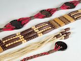 several different types of belts are laid out on a white surface